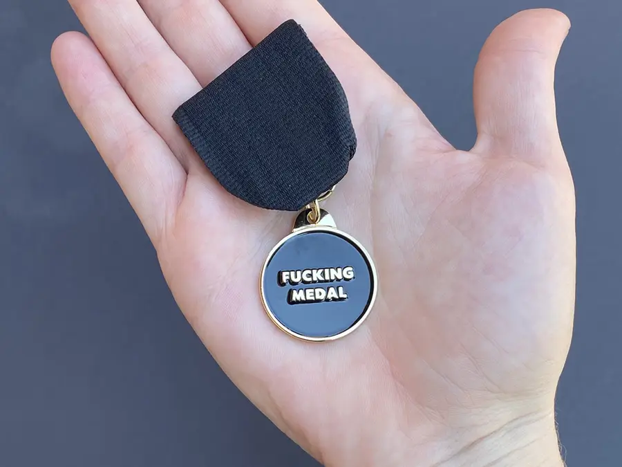 Fucking Medal held in a hand, for scale
